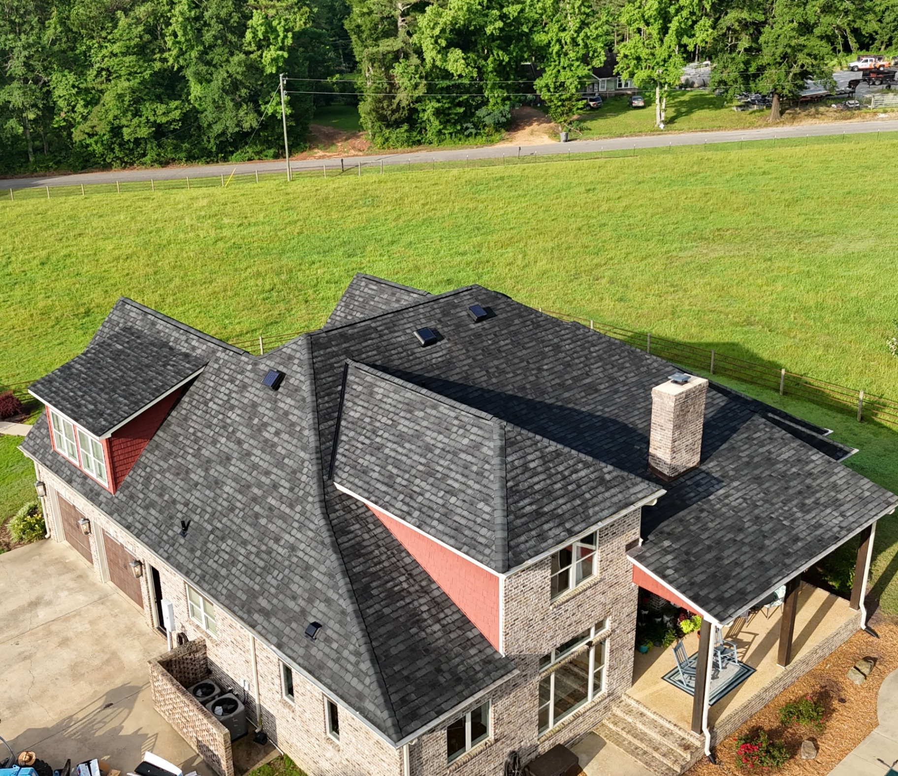 New architectural shingle roof on large two-story home with chimney in West Point MS